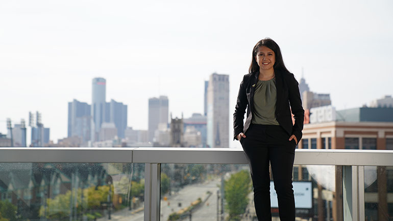 Alexis Rivera standing on the balcony of the Mike Ilitch School of Business